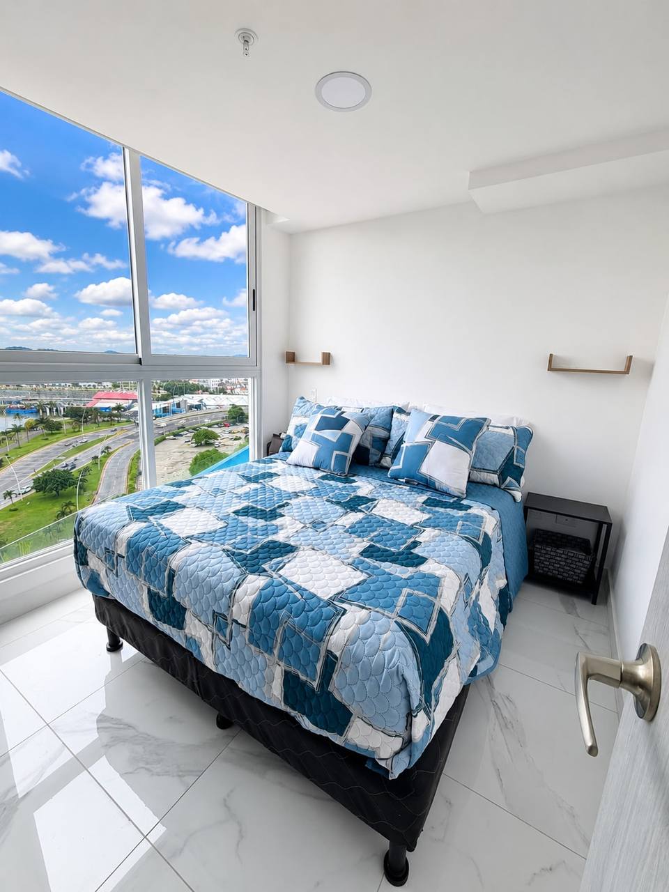 Primary bedroom with floor-to-ceiling windows
