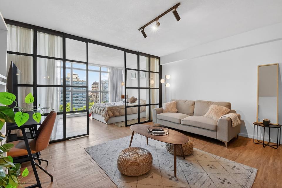 Living room and bedroom separated by glass panels