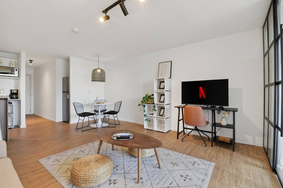 Living room, integrated kitchen, and dining area with round table