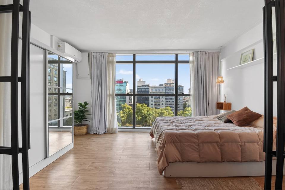 Bright bedroom with views and a double bed