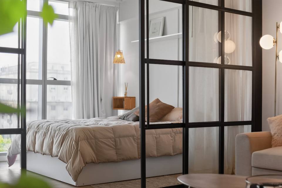 Bedroom separated by industrial chic partition