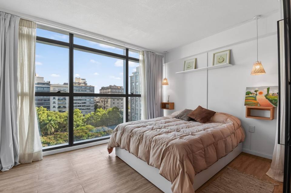 Comfy double bed and large window with city view