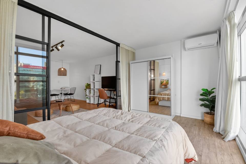 Integrated space with glass divider and wardrobe