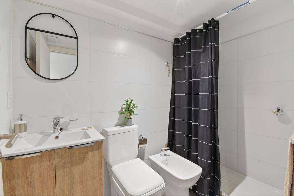 Bathroom with toilet, bidet, shower, and vanity