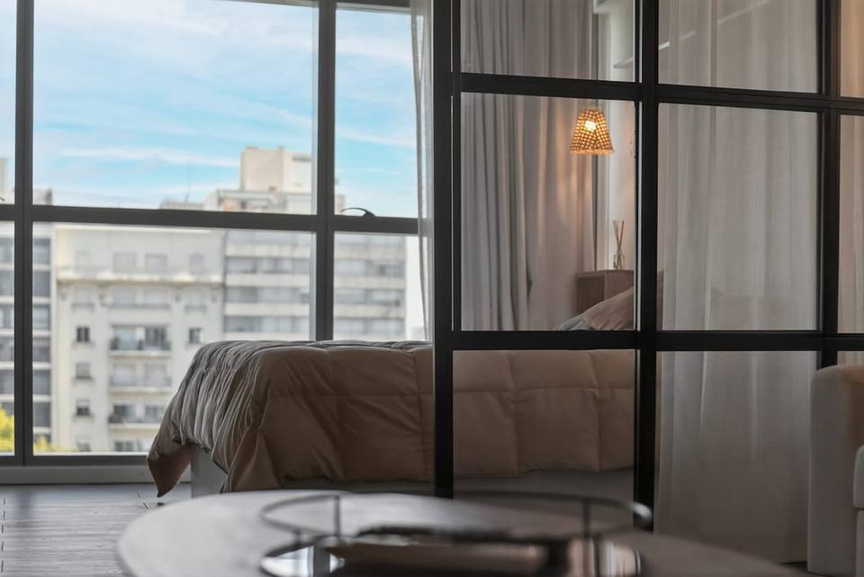 Bedroom view from living area through glass partition