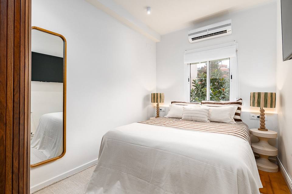 Dormitorio principal con cama doble y aire acondicionado