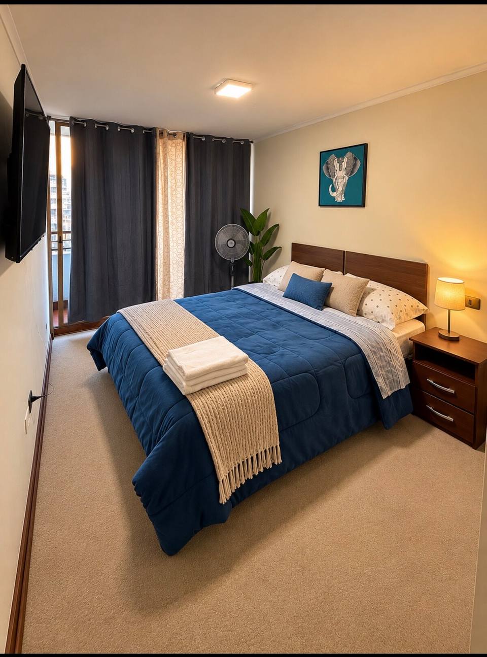 Master bedroom with queen bed and Smart TV